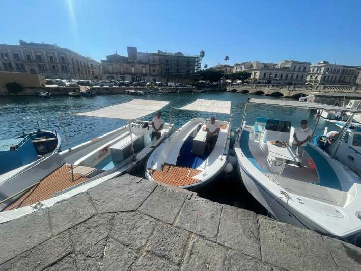 2.5-HOUR BOAT TOUR ORTIGIA+SEA CAVES+PILLIRINA+FRUIT DRINK - Ortigia north-coast views: caves, walls, and Syracuse landmarks from sea level