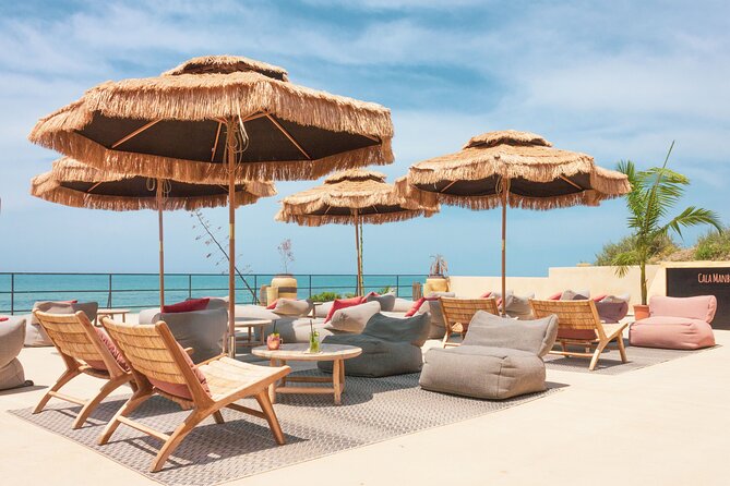 Full Day Pass to Cala Manbrù Beach Club - Timing your visit: opening hours in April/May vs June
